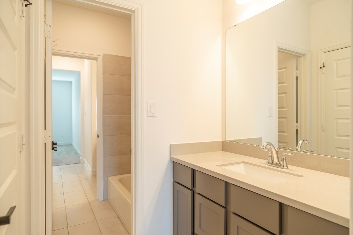 29856 Smoky Ridge Road Fulshear, TX 77441 - Photo 26 of 36 a bathroom with a sink and a mirror