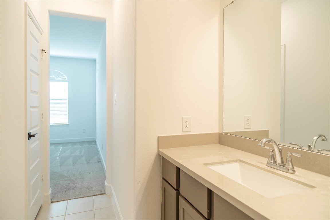 29856 Smoky Ridge Road Fulshear, TX 77441 - Photo 27 of 36 a bathroom with a sink and a mirror