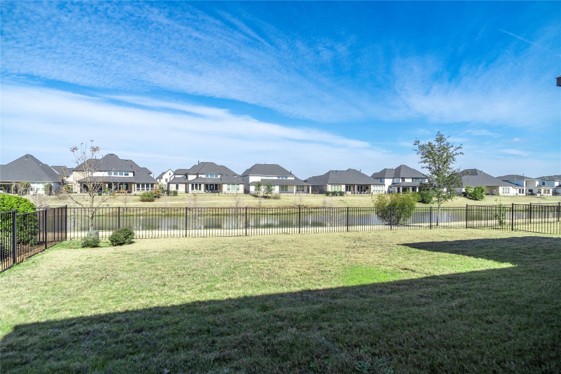 29856 Smoky Ridge Road Fulshear, TX 77441 - Photo 32 of 36 a view of a lake with houses in the background