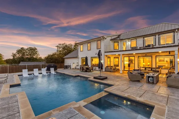 a view of a swimming pool with outdoor seating