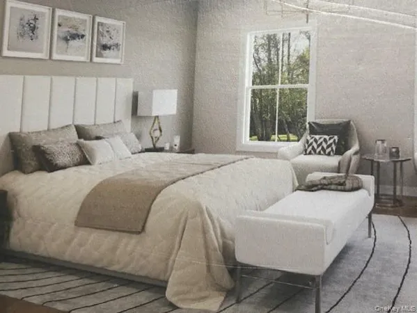 a bedroom with a bed and a large window