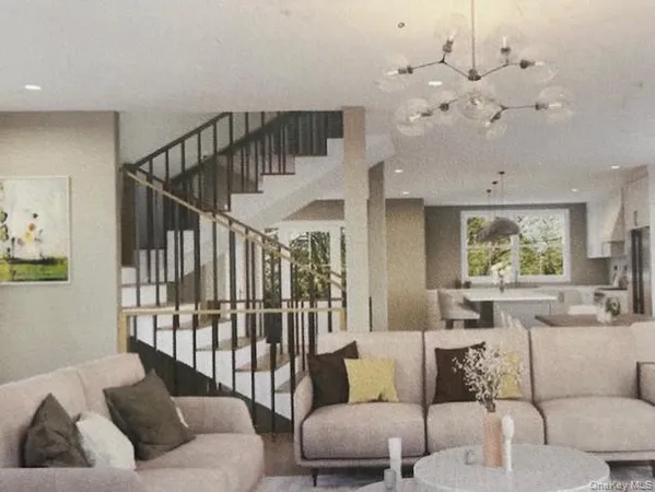 a living room with furniture flowers and a chandelier