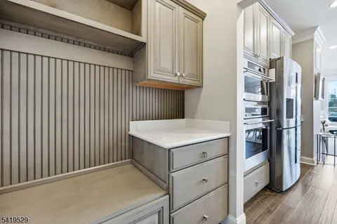 a kitchen with stainless steel appliances granite countertop a refrigerator and a stove top oven
