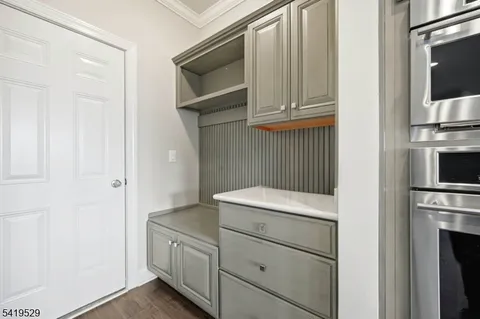 a kitchen with white cabinets and white appliances