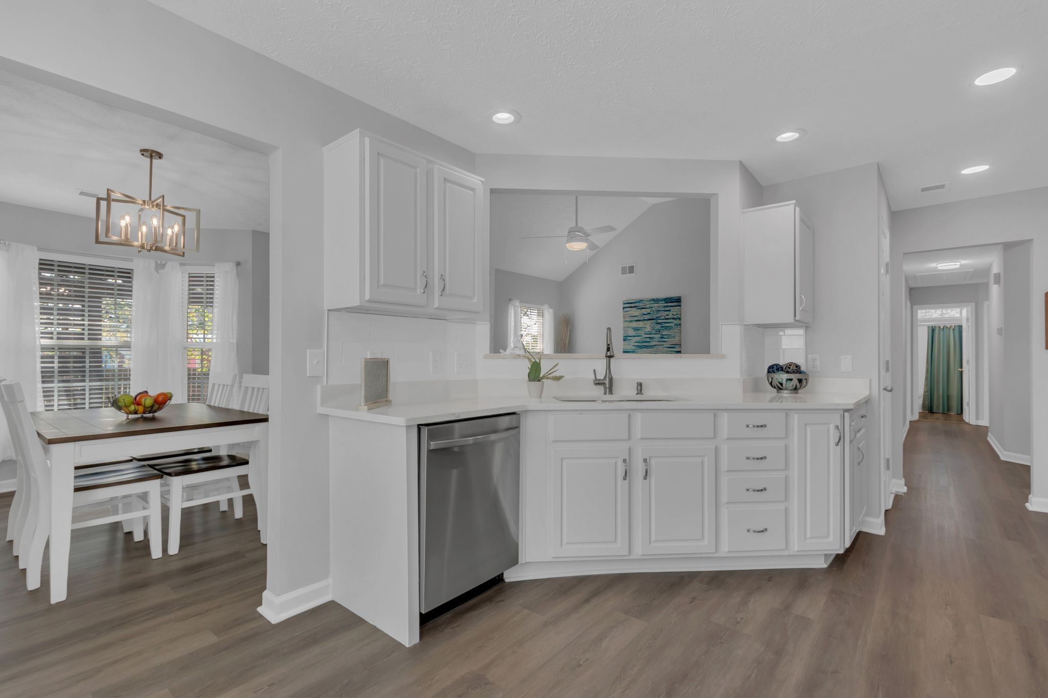 3324 Monoco Drive Spring Hill, TN 37174 - Photo 11 of 31 a kitchen with stainless steel appliances kitchen island wooden floors and white cabinets