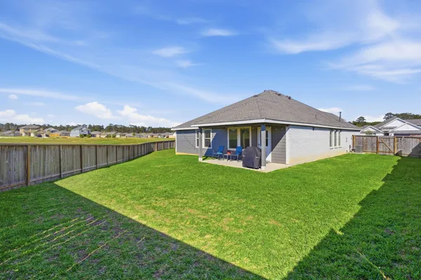 a view of a house with backyard porch and garden