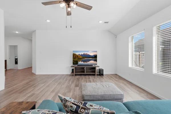 a living room with furniture and a flat screen tv