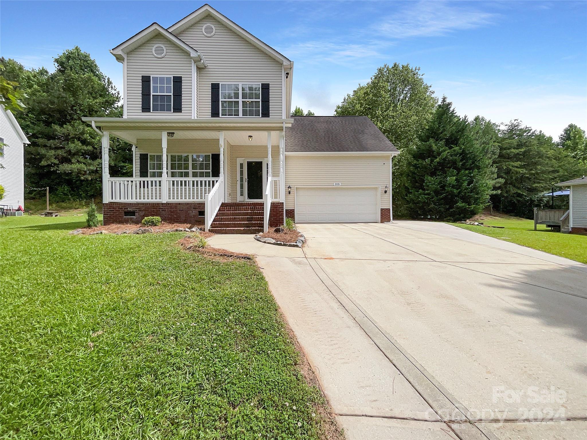 315 Lone Tree Lane Clover, SC 29710 - Photo 1 of 15 a view of a house with backyard sitting area and garden
