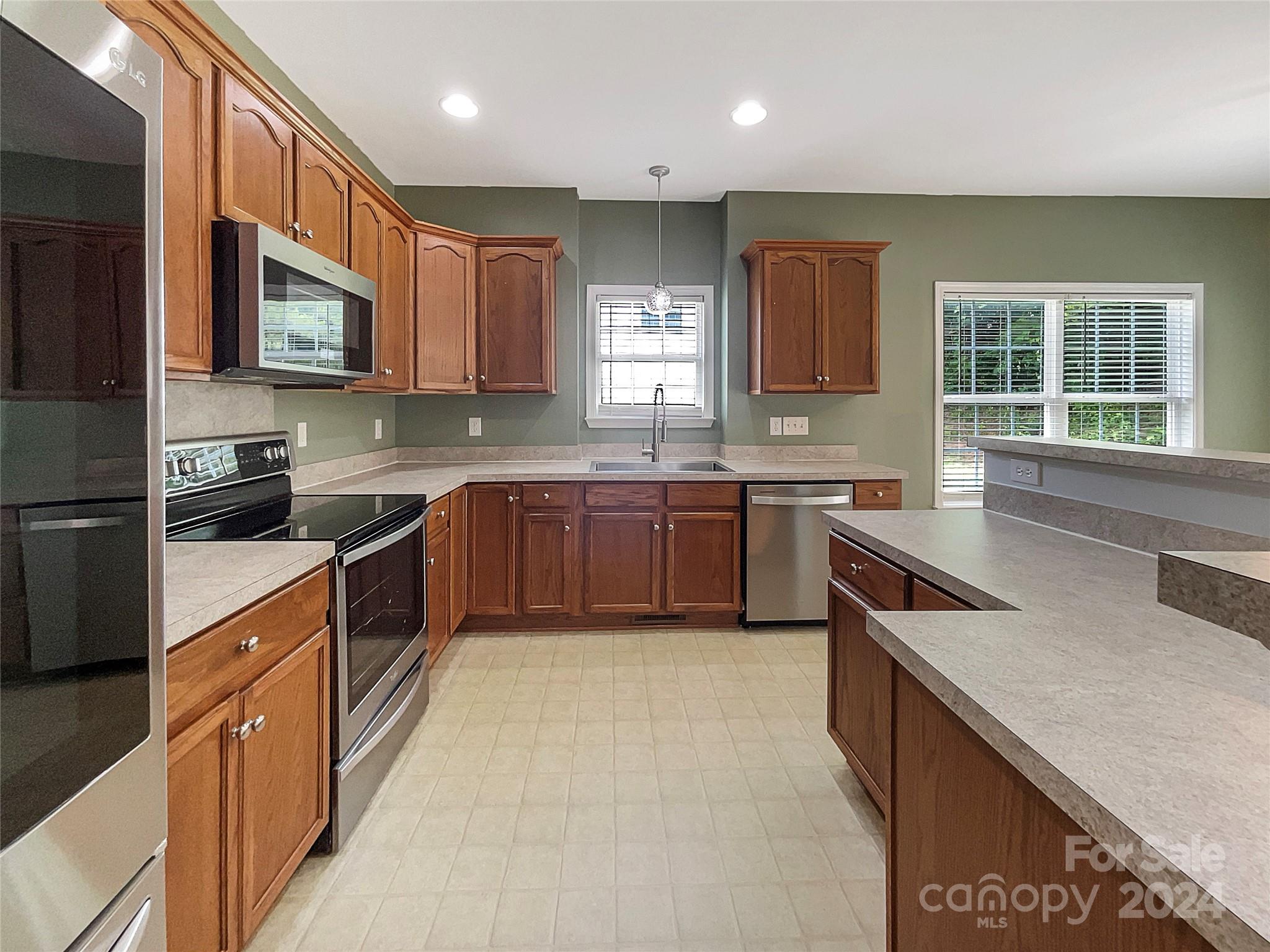 315 Lone Tree Lane Clover, SC 29710 - Photo 7 of 15 a kitchen with stainless steel appliances granite countertop wooden cabinets a sink and a stove