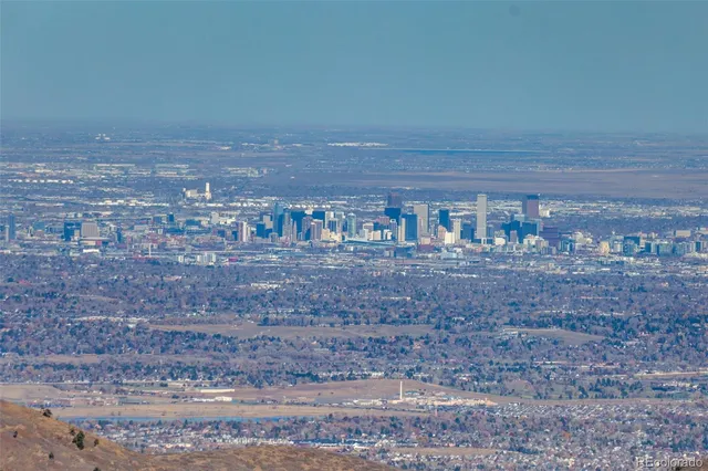 a kitchen with stainless steel appliances kitchen island granite countertop a table chairs in it and wooden floors