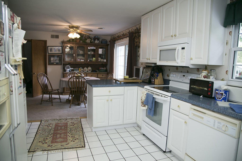 4405 Royalview Road Knoxville, TN 37921 - Photo 14 of 38 a kitchen with white cabinets and appliances