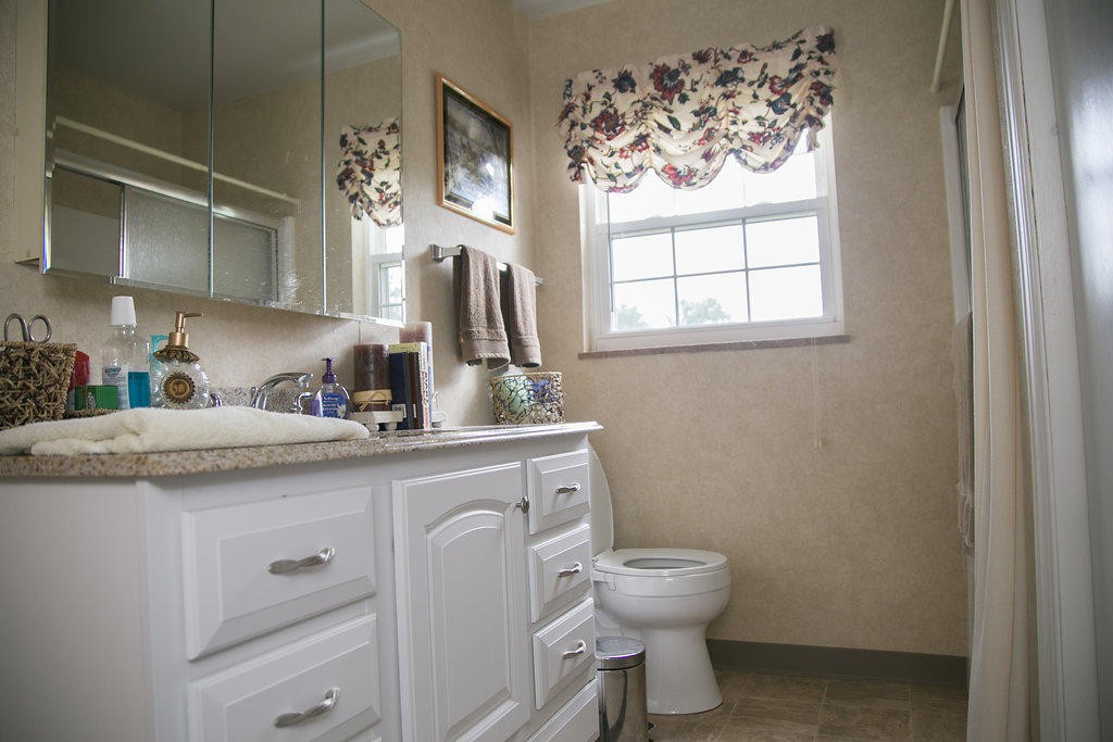 4405 Royalview Road Knoxville, TN 37921 - Photo 25 of 38 a bathroom with a toilet sink and mirror