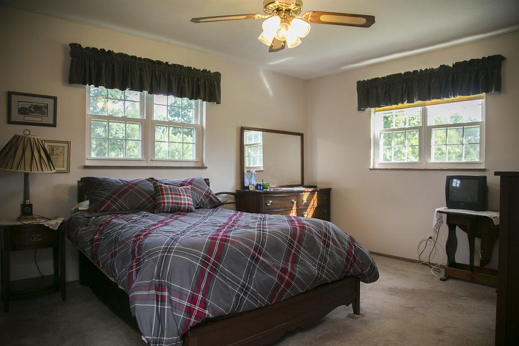 4405 Royalview Road Knoxville, TN 37921 - Photo 27 of 38 a bed room with a bed and a chandelier