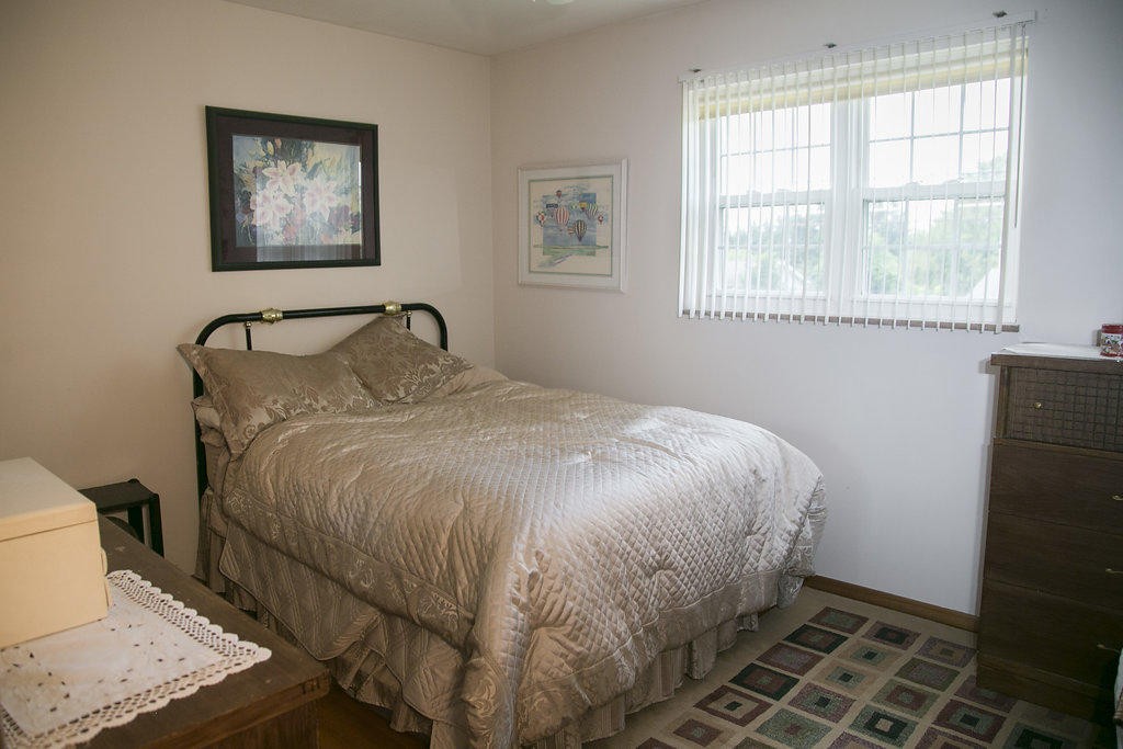 4405 Royalview Road Knoxville, TN 37921 - Photo 31 of 38 a bed sitting in a bedroom next to a window