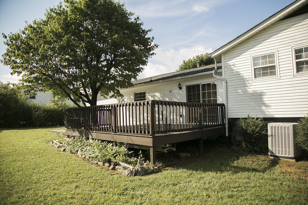4405 Royalview Road Knoxville, TN 37921 - Photo 10 of 38 a view of a house with a deck and a yard