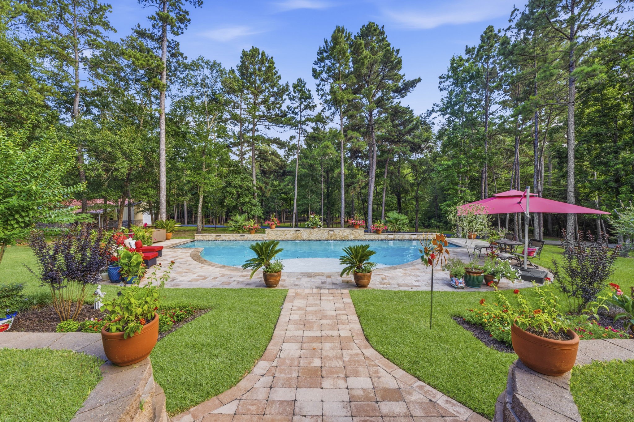 280 Sundog Road Huntsville, TX 77340 - Photo 42 of 50 Gorgeous resort-style pool with both heater and chiller offers refreshing swims during warm Texas days and comfortable enjoyment throughout the year.