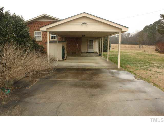 359 Harvey Road Kenly, NC 27542 - Photo 4 of 21 Concrete drive with attached carport, storage and covered patio could be additional parking Parking Lot/Garage