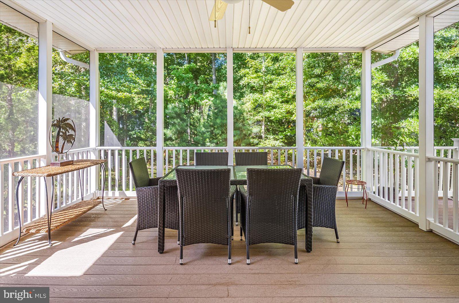91 Robin Hood Trail Ocean Pines, MD 21811 - Photo 15 of 71 a view of a dining room with wooden floor glass walls and windows