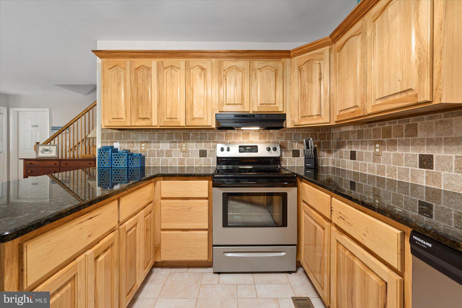 91 Robin Hood Trail Ocean Pines, MD 21811 - Photo 23 of 71 a kitchen with stainless steel appliances granite countertop a stove and a sink