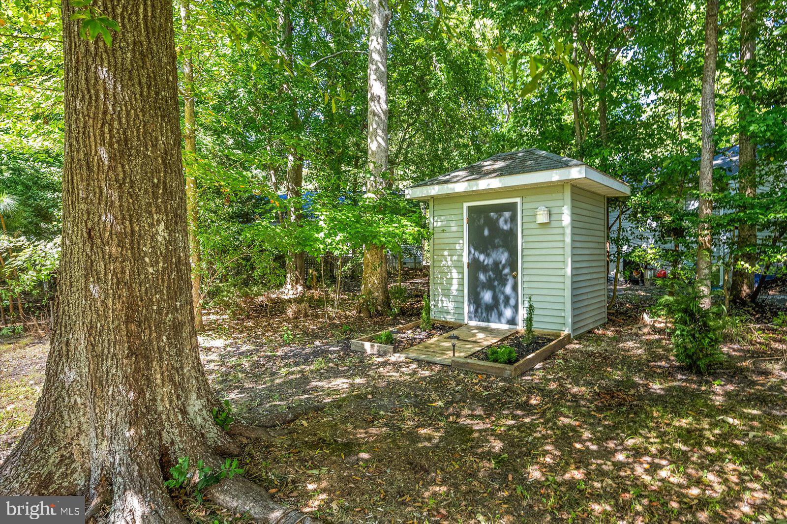 91 Robin Hood Trail Ocean Pines, MD 21811 - Photo 54 of 71 a view of a wooden house with large trees