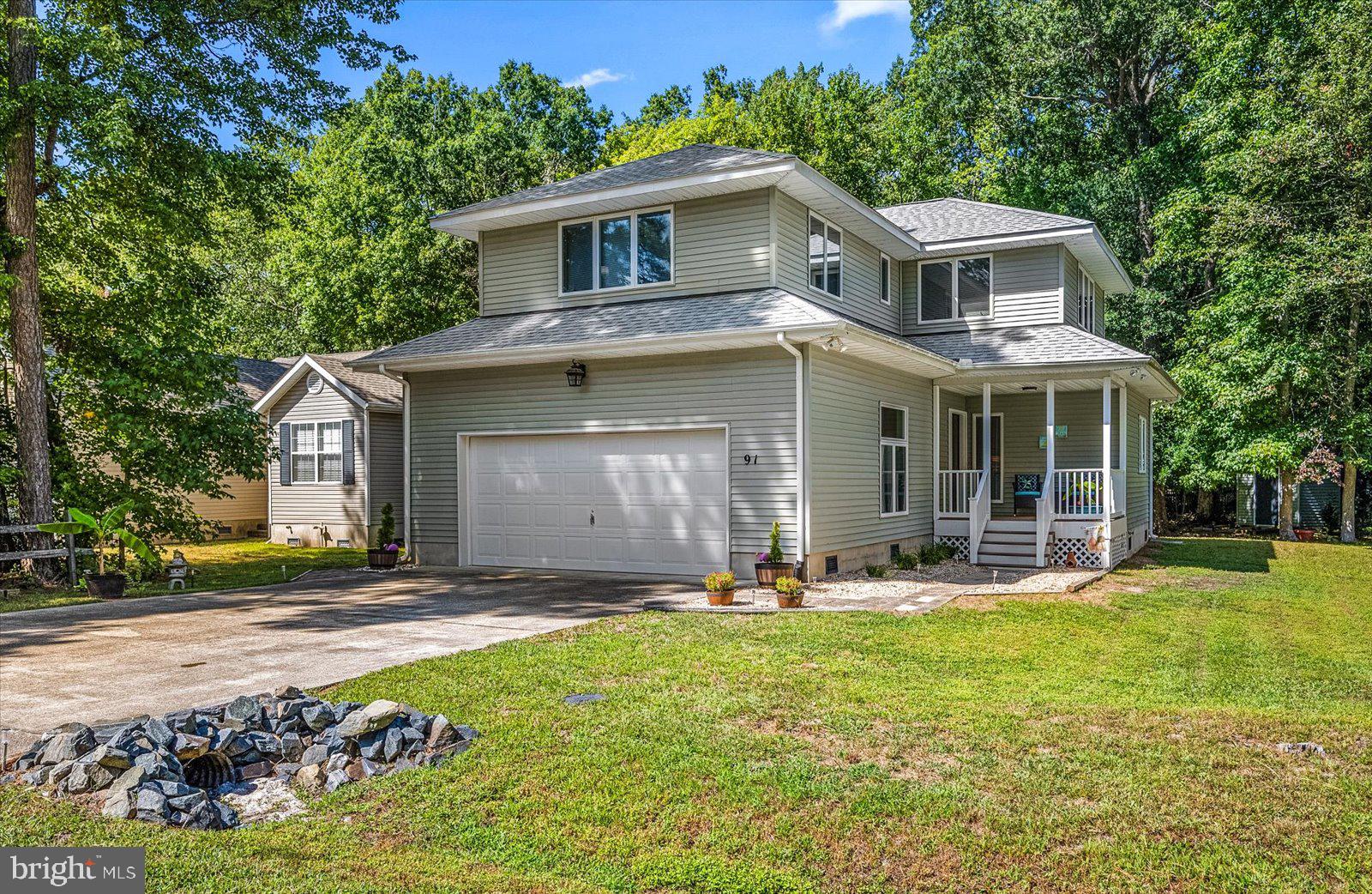 91 Robin Hood Trail Ocean Pines, MD 21811 - Photo 57 of 71 a front view of a house with a yard and garage
