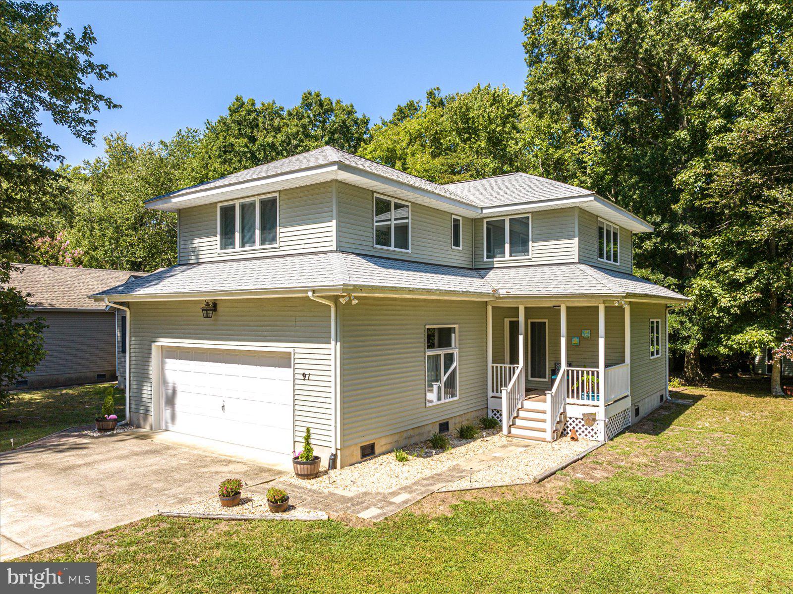 91 Robin Hood Trail Ocean Pines, MD 21811 - Photo 70 of 71 a front view of a house with a yard and garage