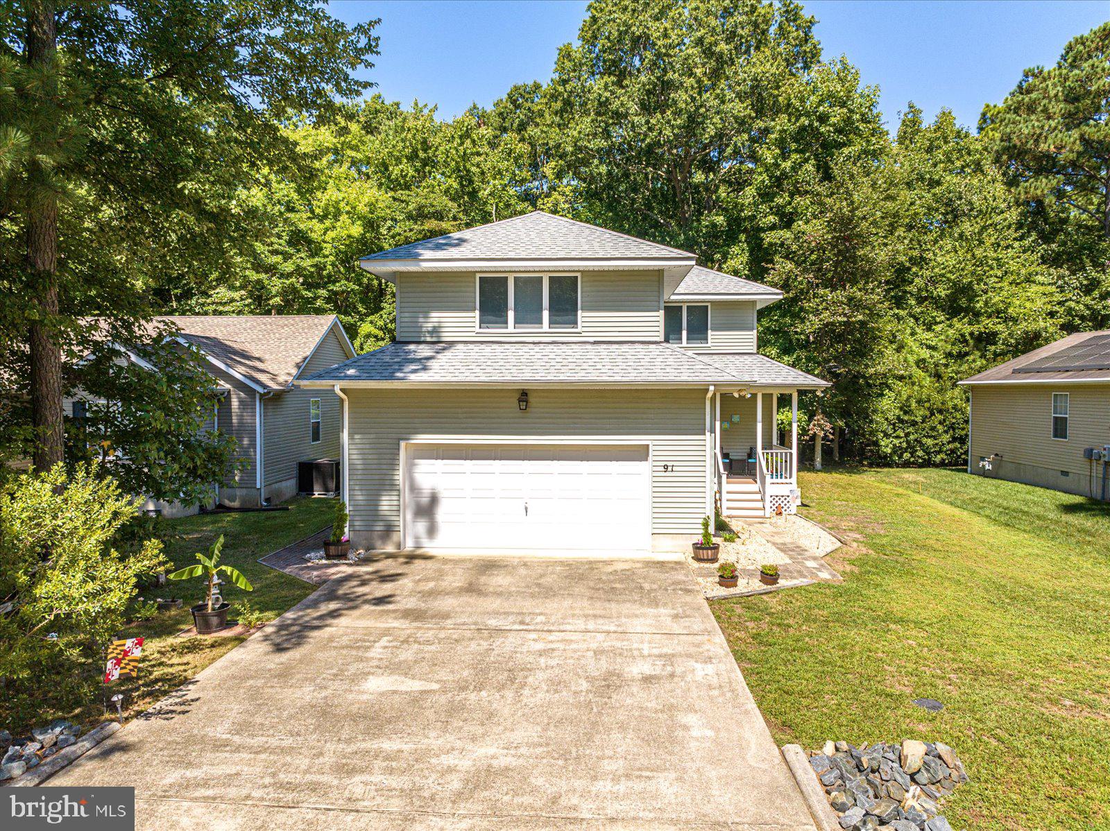 91 Robin Hood Trail Ocean Pines, MD 21811 - Photo 71 of 71 a front view of a house with a yard and garage