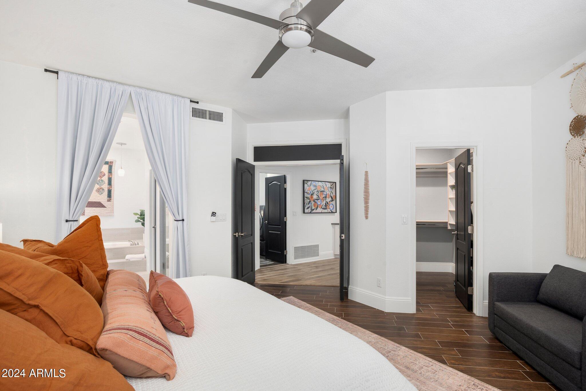 7705 East Doubletree Ranch Road, Unit 38 Scottsdale, AZ 85258 - Photo 14 of 31 a bedroom with a bed and a couch