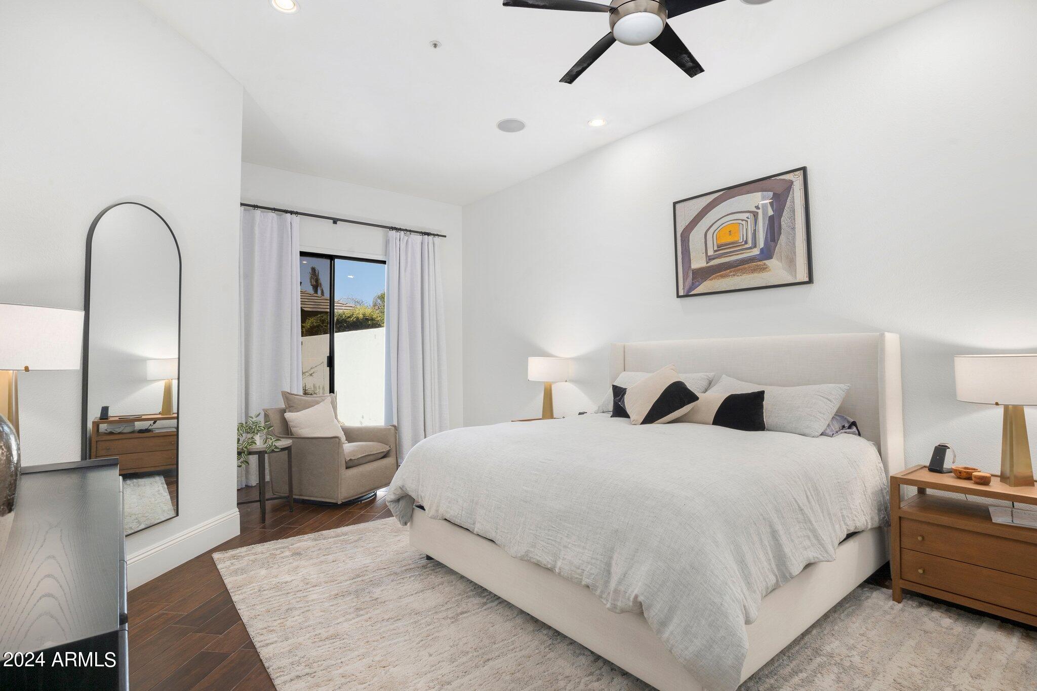 7705 East Doubletree Ranch Road, Unit 38 Scottsdale, AZ 85258 - Photo 18 of 31 a bedroom with a bed and a large window