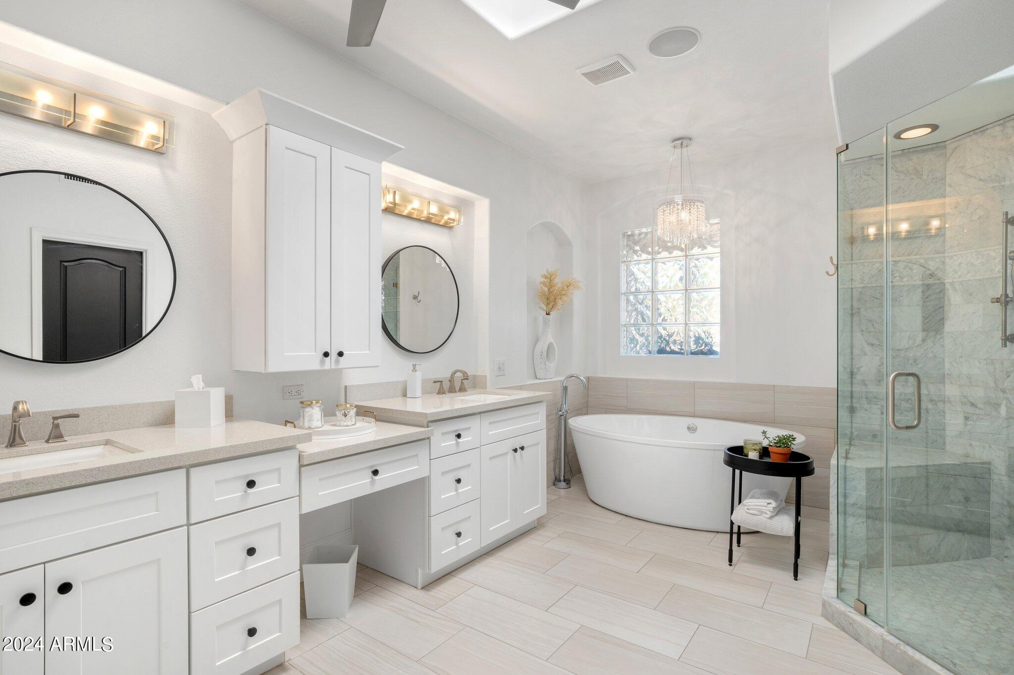 7705 East Doubletree Ranch Road, Unit 38 Scottsdale, AZ 85258 - Photo 21 of 31 a spacious bathroom with a double vanity sink mirror and bathtub