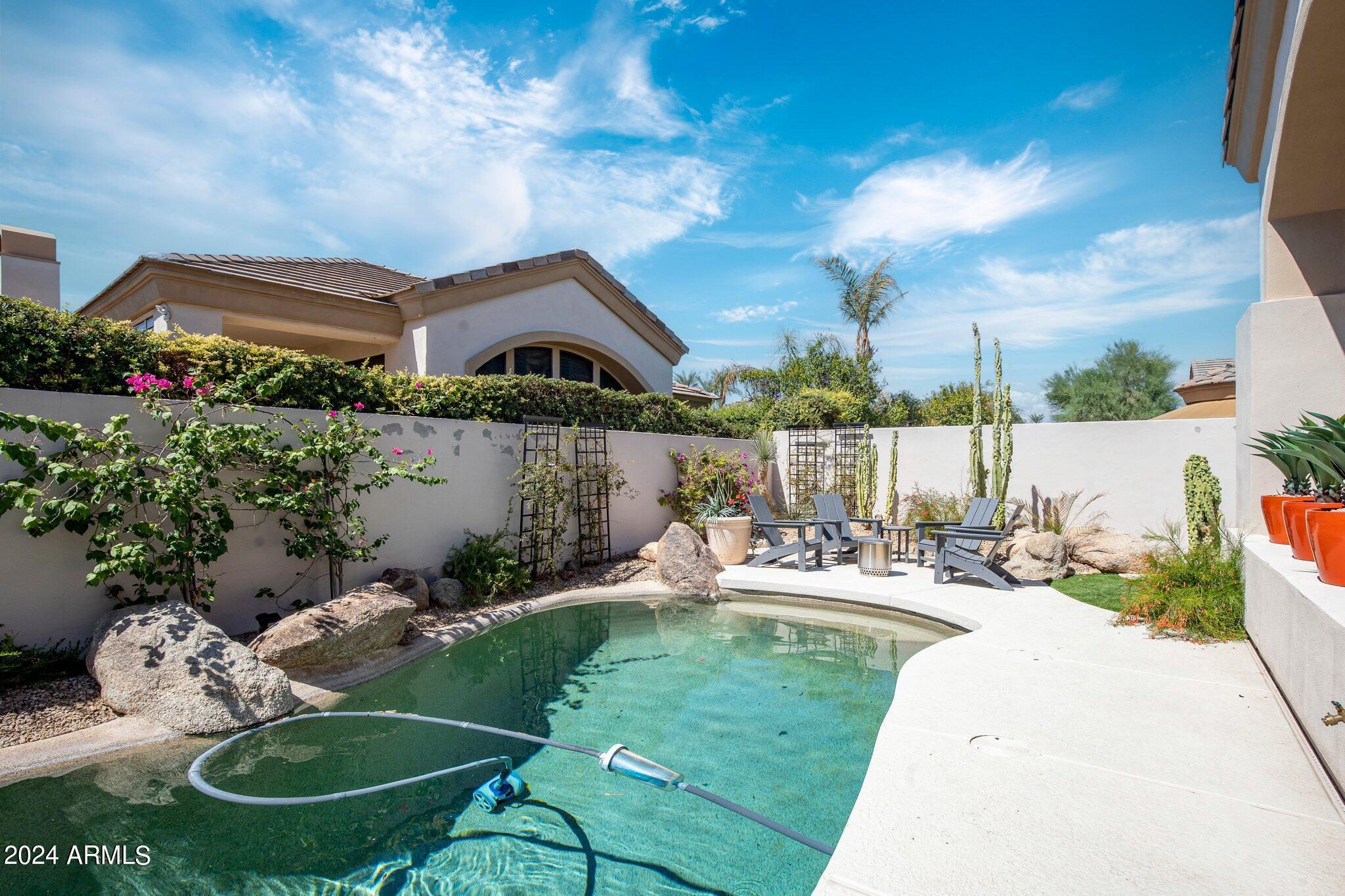 7705 East Doubletree Ranch Road, Unit 38 Scottsdale, AZ 85258 - Photo 27 of 31 a view of a chair and table in backyard of the house
