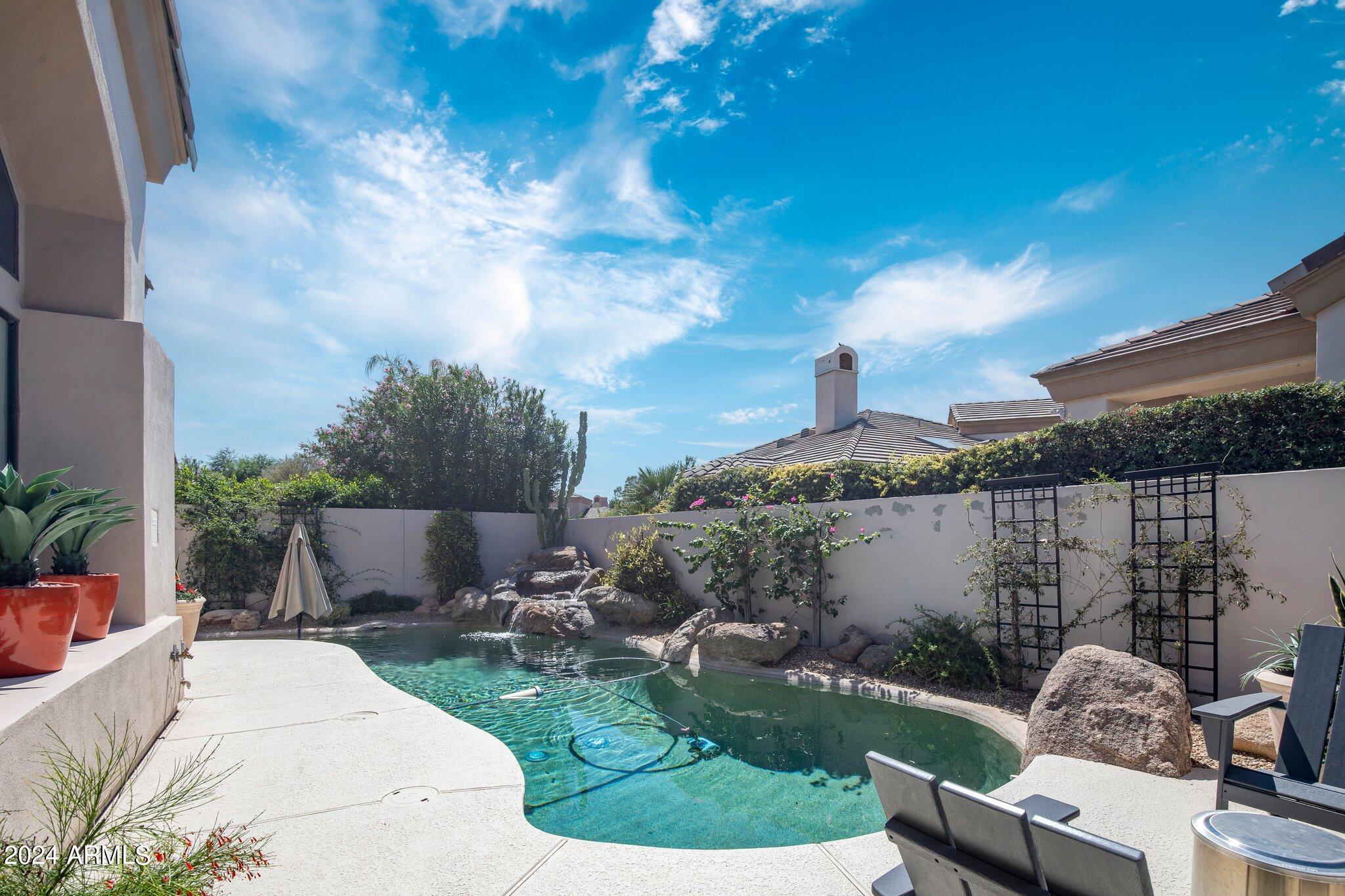 7705 East Doubletree Ranch Road, Unit 38 Scottsdale, AZ 85258 - Photo 29 of 31 a view of a patio with couches table and chairs and potted plants