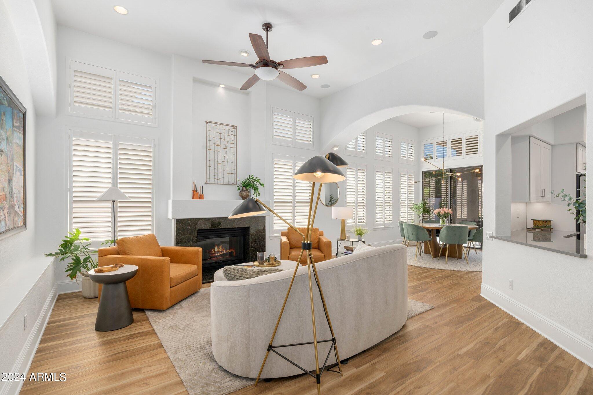 7705 East Doubletree Ranch Road, Unit 38 Scottsdale, AZ 85258 - Photo 3 of 31 a living room with furniture a fireplace and a chandelier