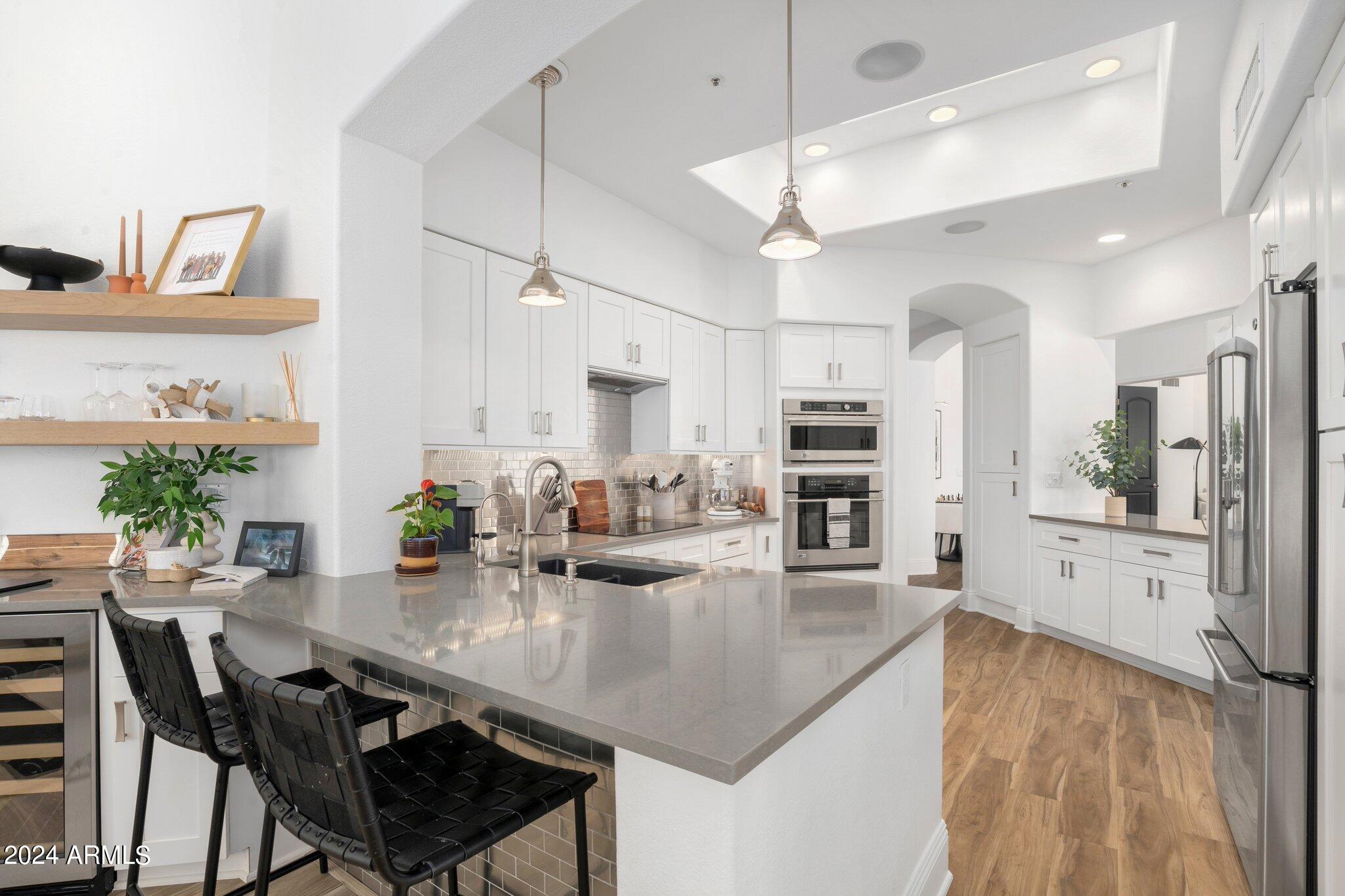 7705 East Doubletree Ranch Road, Unit 38 Scottsdale, AZ 85258 - Photo 9 of 31 a kitchen with stainless steel appliances granite countertop a stove refrigerator and cabinets