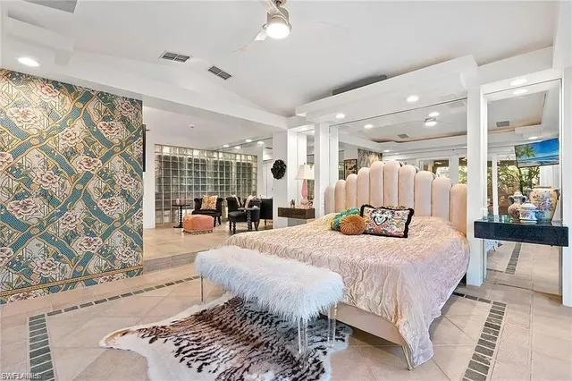 a bedroom with a large bed and a couch