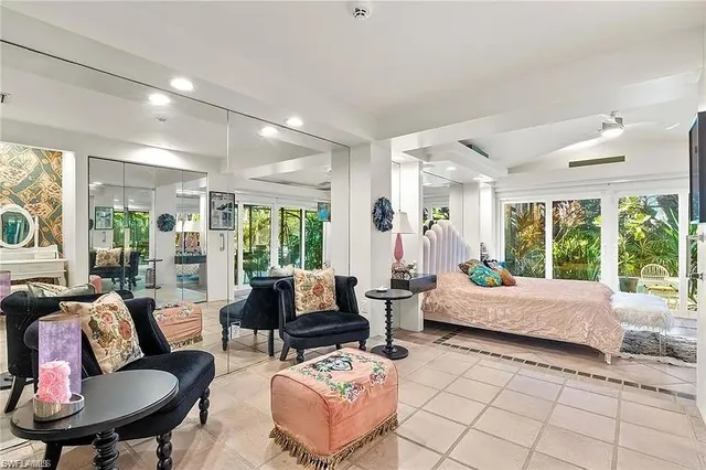 a living room with furniture and large windows