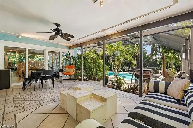 a view of a dining room with furniture large windows and outside view