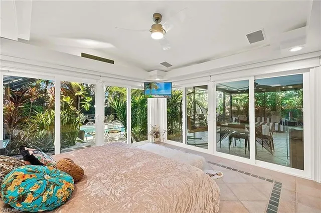 a bedroom with furniture and large windows