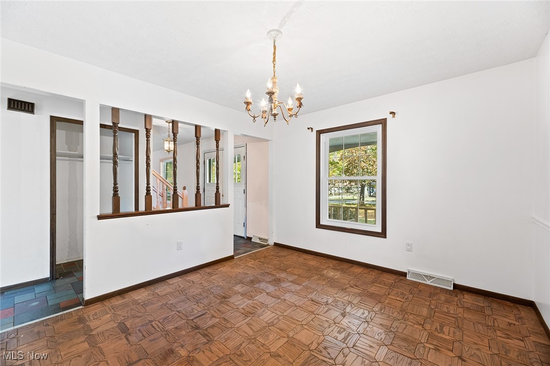 3550 Boston Road Brunswick, OH 44212 - Photo 12 of 37 Unfurnished room featuring baseboards and a chandelier