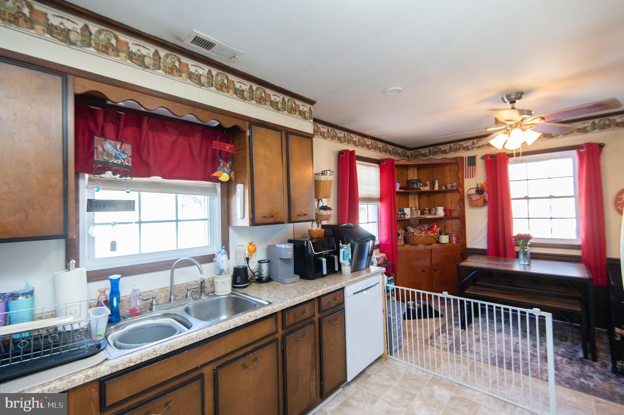 133 South Street Secretary, MD 21664 - Photo 13 of 39 a kitchen with granite countertop a sink stove and cabinets