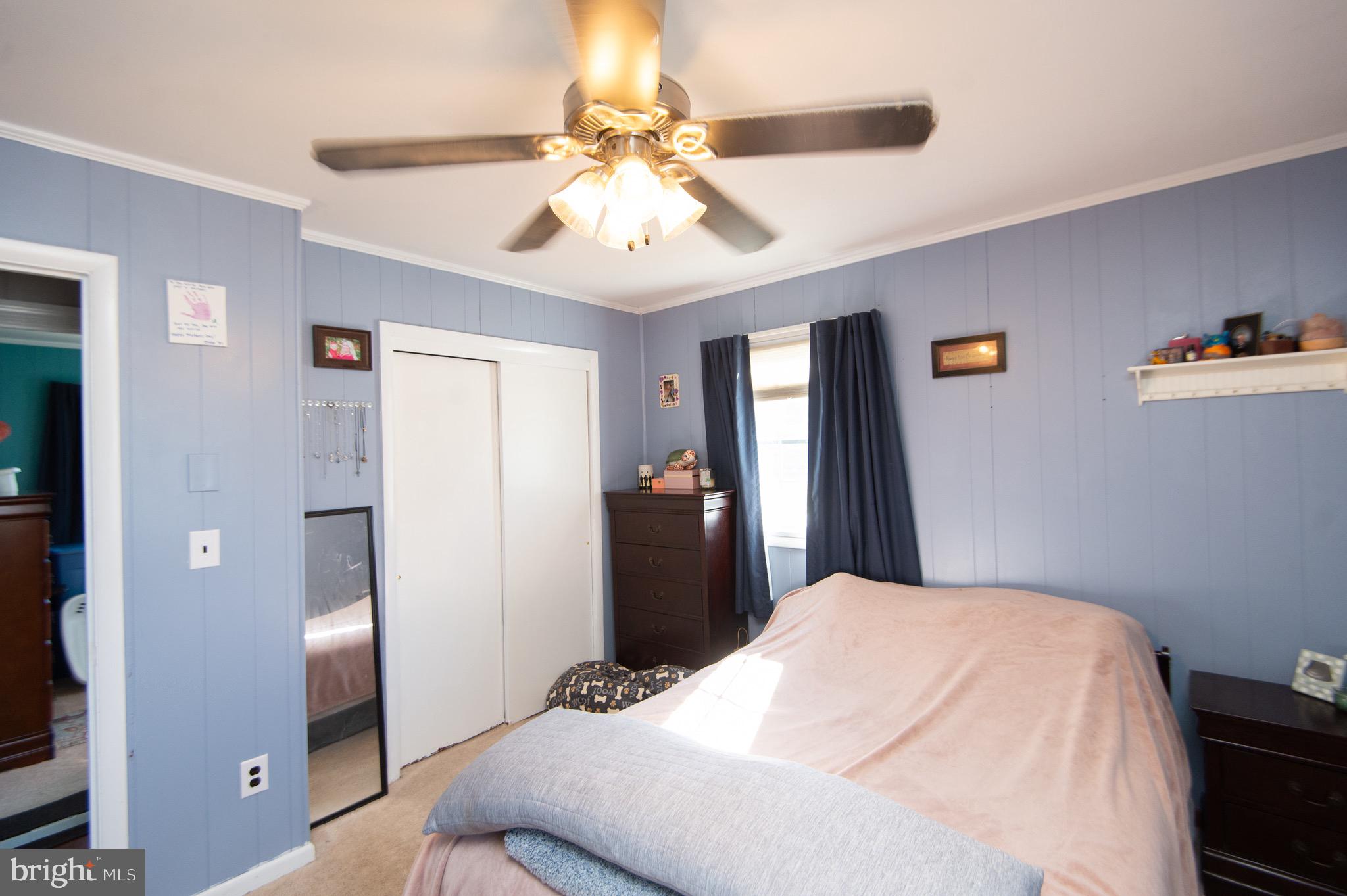 133 South Street Secretary, MD 21664 - Photo 22 of 39 a bedroom with a bed and a chandelier