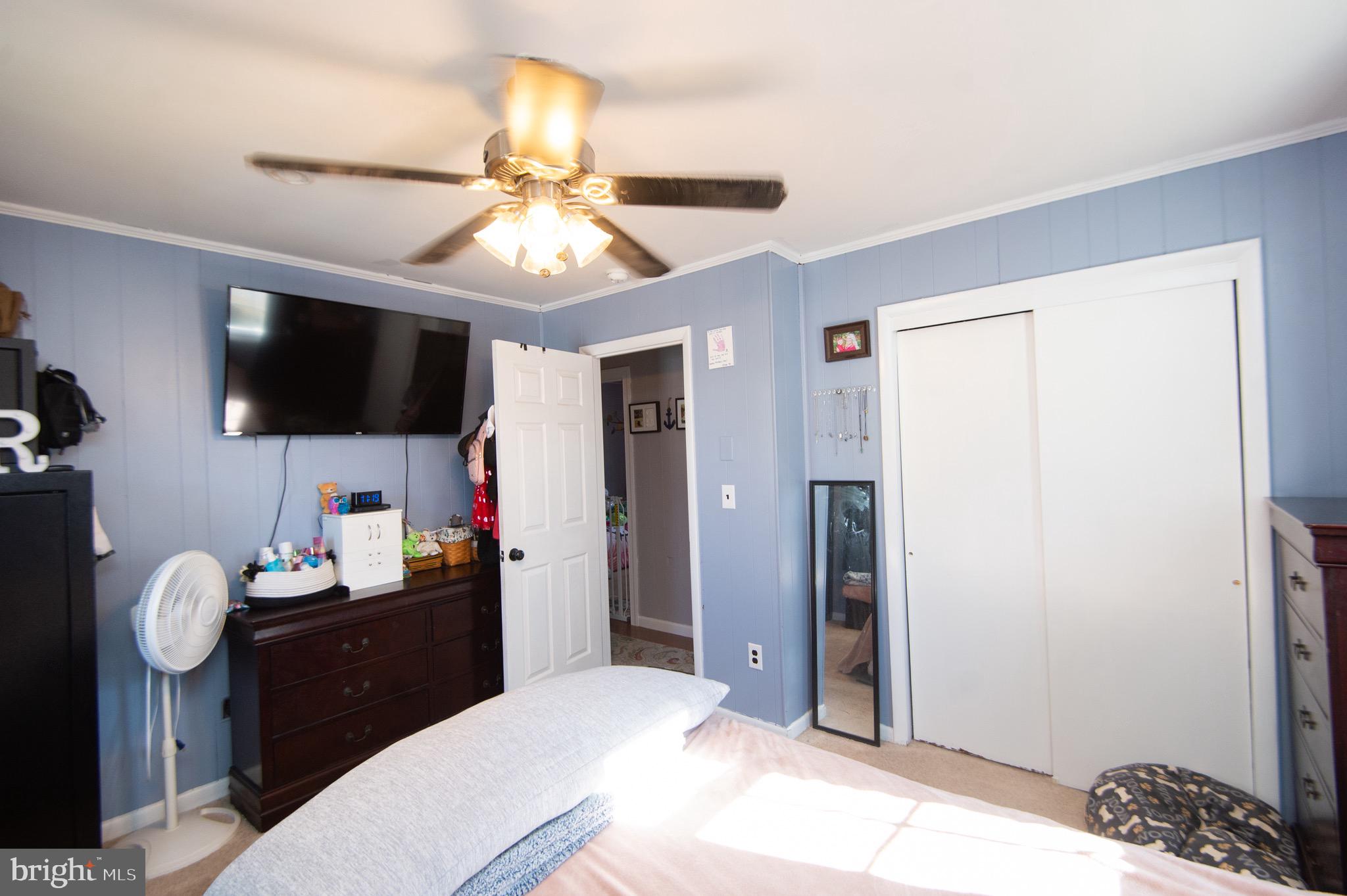 133 South Street Secretary, MD 21664 - Photo 23 of 39 a bedroom with a bed and a flat screen tv