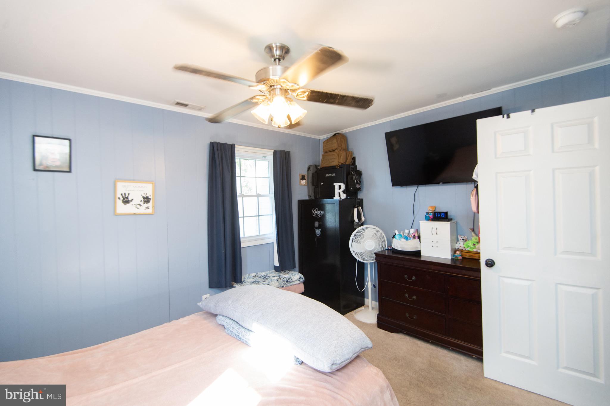 133 South Street Secretary, MD 21664 - Photo 24 of 39 a bedroom with a bed and a flat screen tv