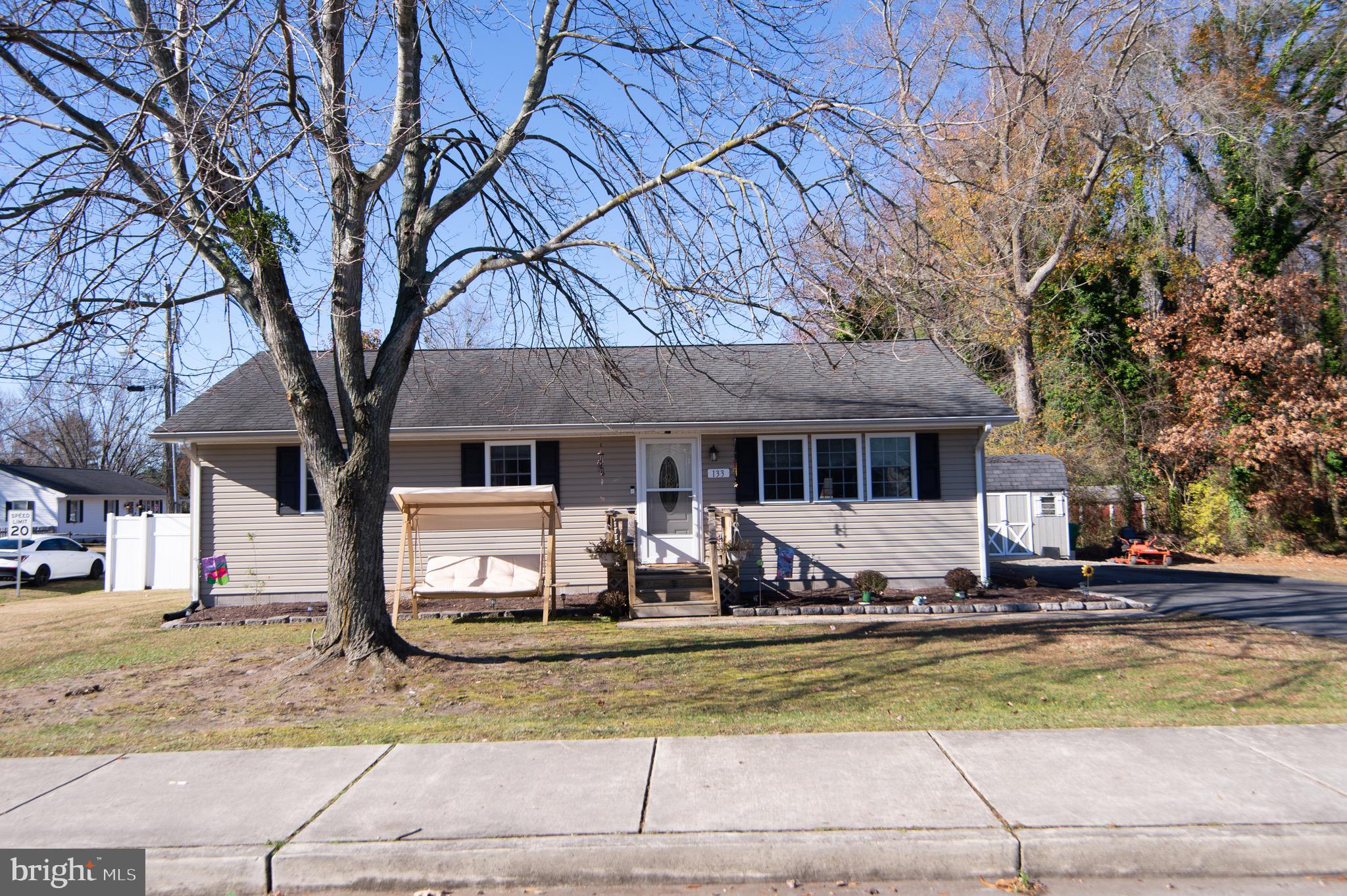 133 South Street Secretary, MD 21664 - Photo 3 of 39 a front view of a house with a yard covered with snow