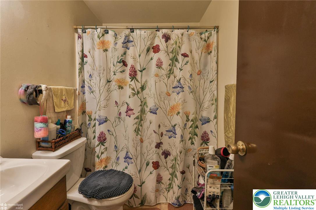 802 West Berwick Street Easton, PA 18042 - Photo 22 of 54 a bathroom with a toilet and a shower curtain