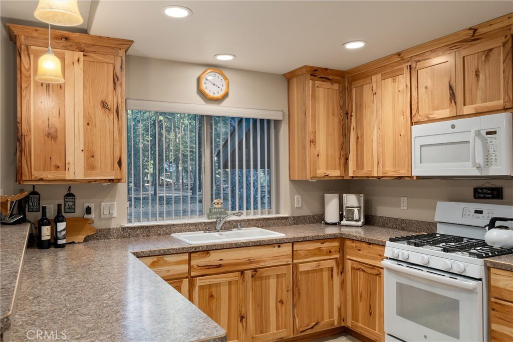 7528 Humboldt Road Butte Meadows, CA 95942 - Photo 15 of 41 a kitchen with stainless steel appliances granite countertop a stove a sink and a microwave