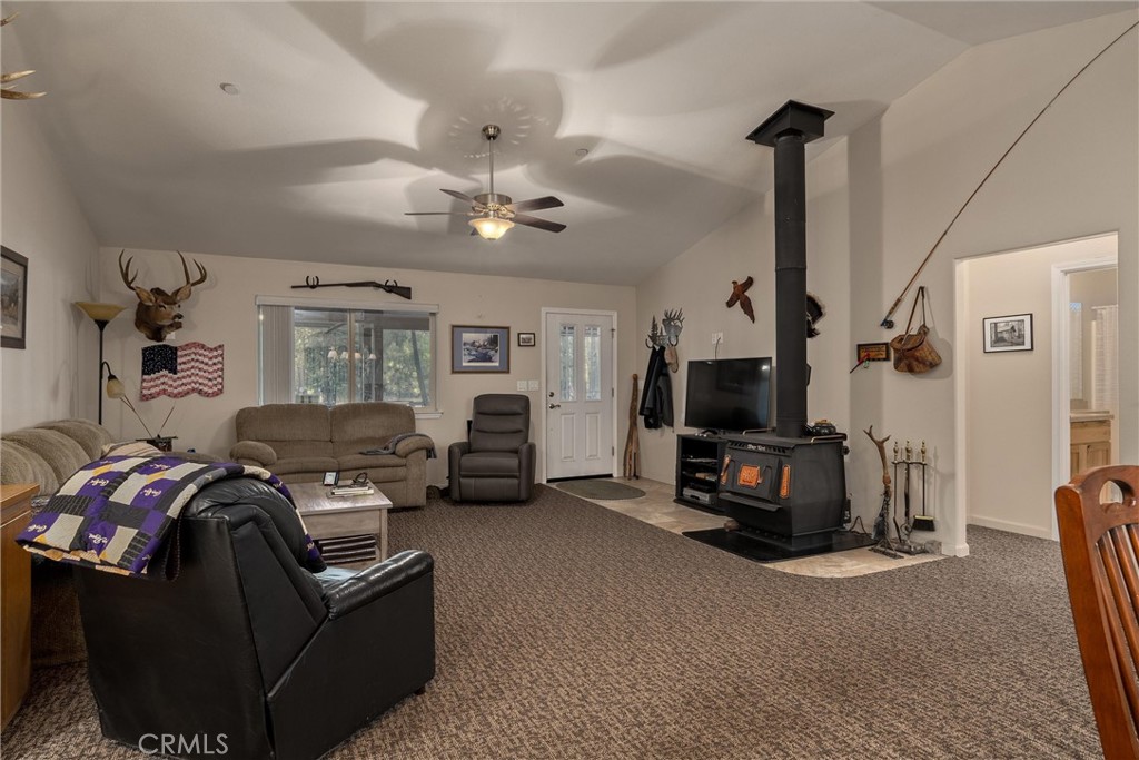 7528 Humboldt Road Butte Meadows, CA 95942 - Photo 9 of 41 a living room with furniture a flat screen tv and a fireplace