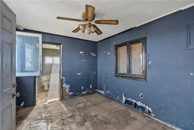 a view of a livingroom with a chandelier fan