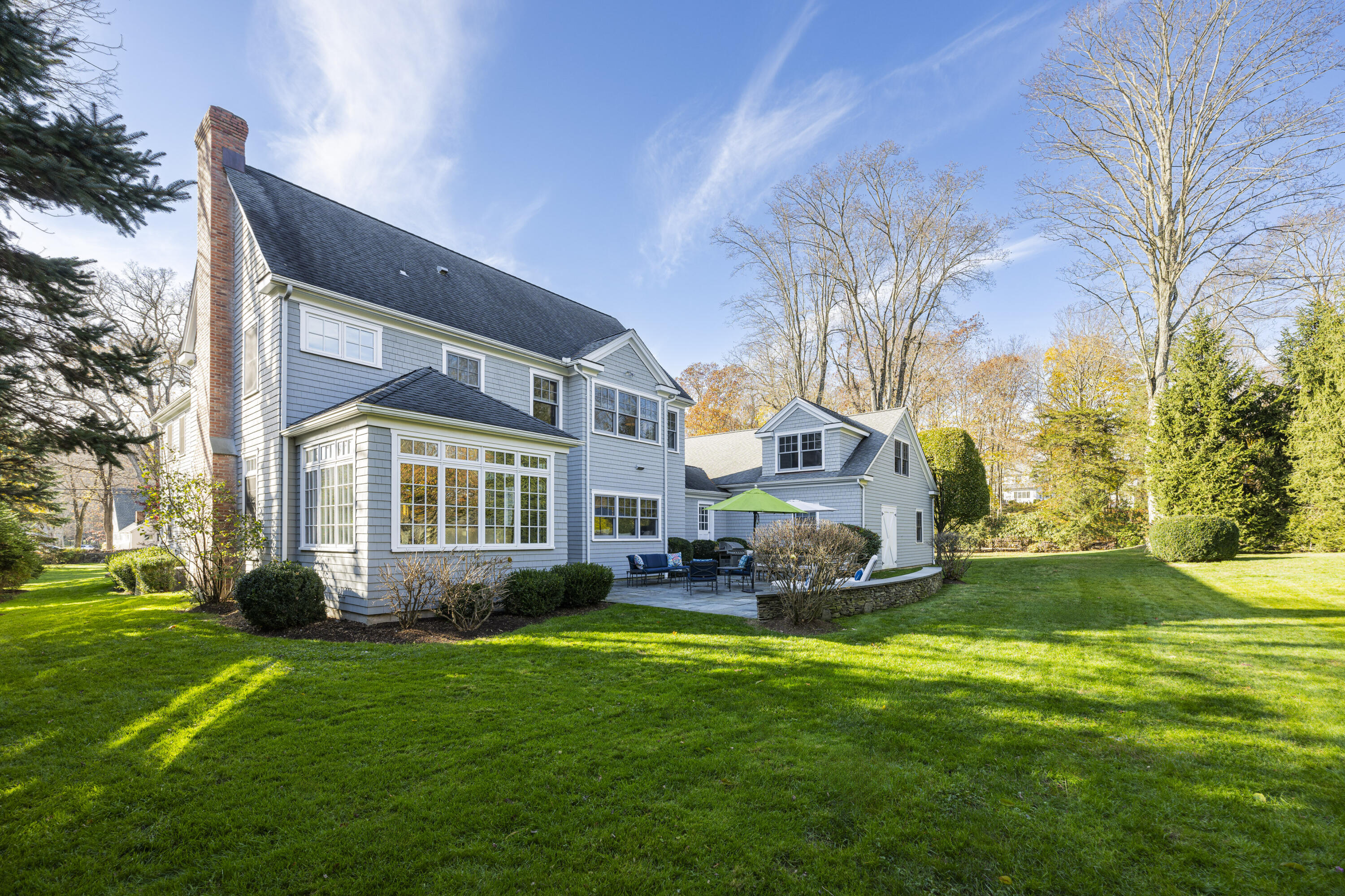 1022 Silvermine Road New Canaan, CT 06840 - Photo 24 of 25 a front view of a house with a garden