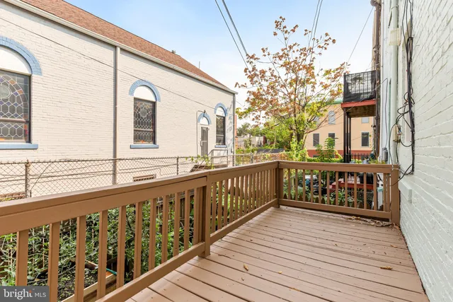 a view of balcony with wooden floor and flowers